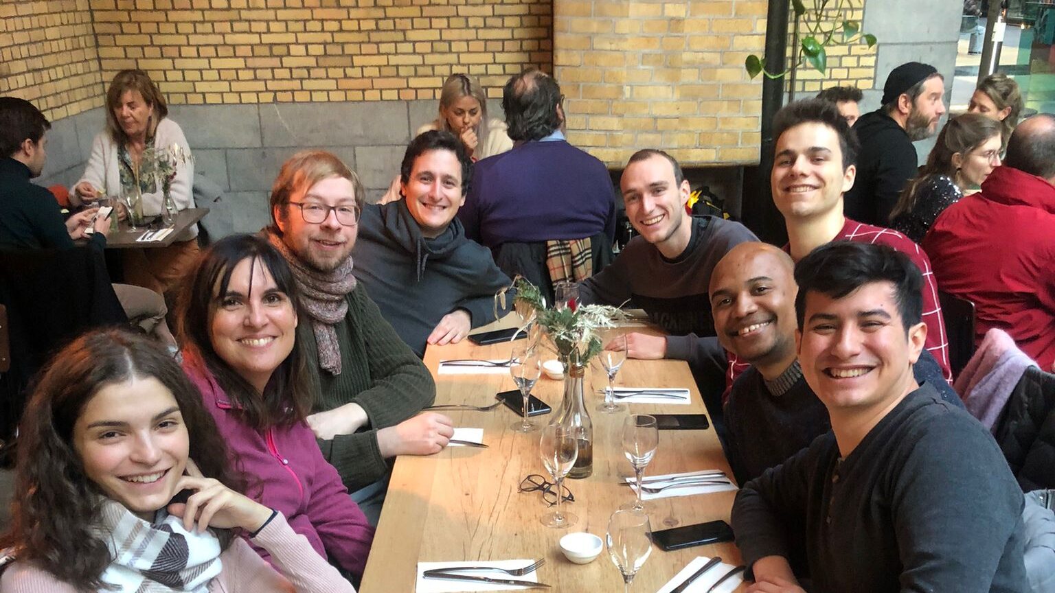 SOFT researchers smiling around a table during a lunch